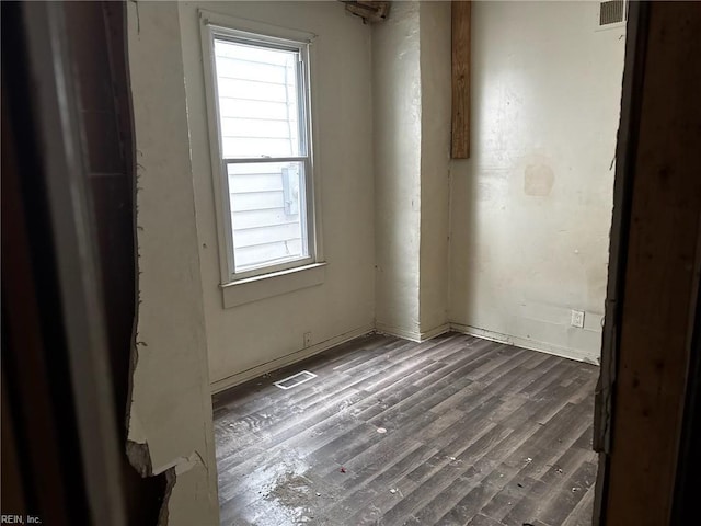 unfurnished room featuring visible vents and wood finished floors