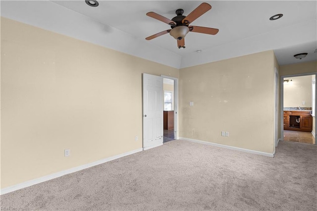 unfurnished bedroom with carpet floors, a ceiling fan, and baseboards