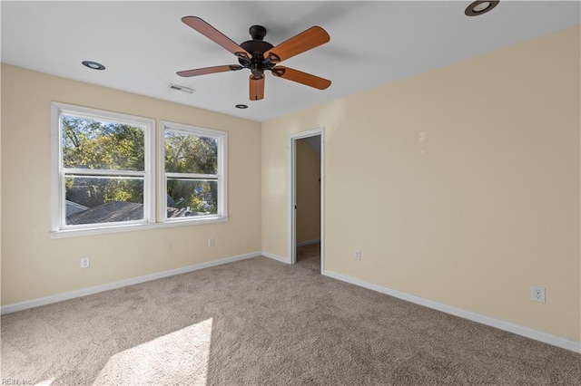 carpeted empty room featuring a ceiling fan, recessed lighting, visible vents, and baseboards