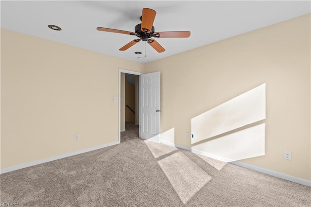 carpeted empty room with baseboards, a ceiling fan, and recessed lighting