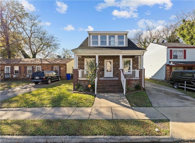 view of front of home with covered porch and a front yard