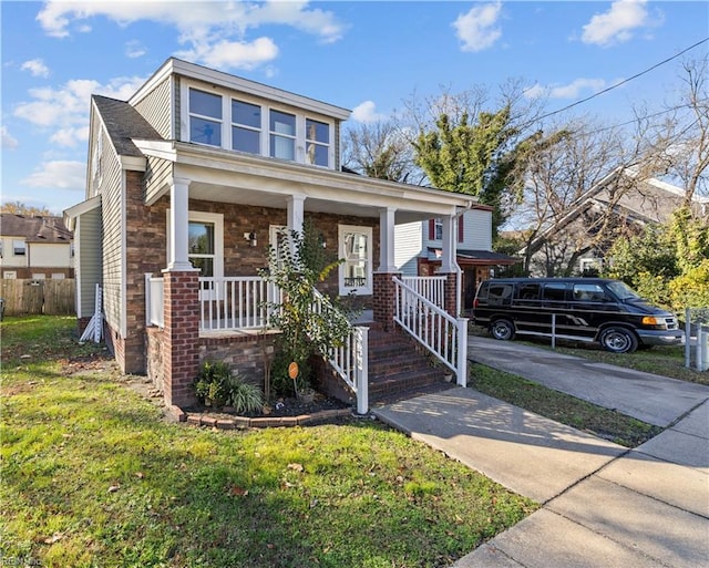 view of front of house with a front yard and covered porch