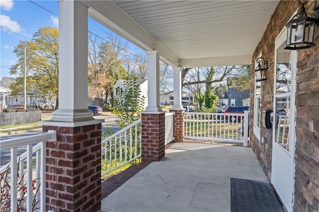 view of patio featuring covered porch and a residential view