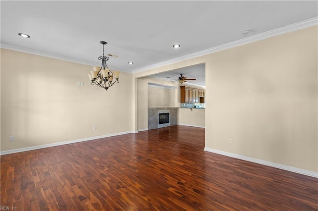 unfurnished living room with ornamental molding, dark wood-type flooring, a tiled fireplace, and baseboards