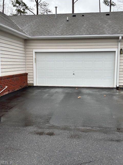 garage with aphalt driveway