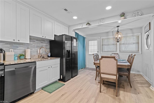 kitchen featuring a sink, refrigerator with ice dispenser, white cabinets, light wood-type flooring, and dishwasher