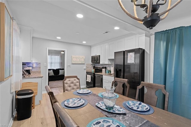 dining area featuring light wood-style flooring, visible vents, baseboards, and recessed lighting