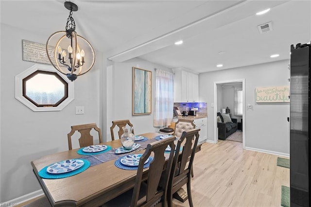 dining area with light wood-style flooring, recessed lighting, visible vents, baseboards, and an inviting chandelier