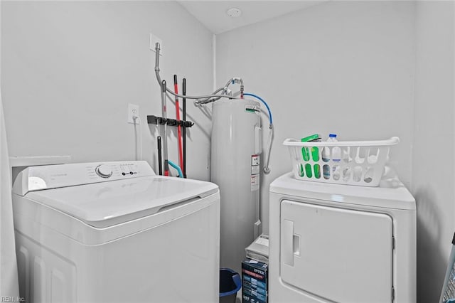 laundry room featuring washer and dryer, laundry area, and electric water heater