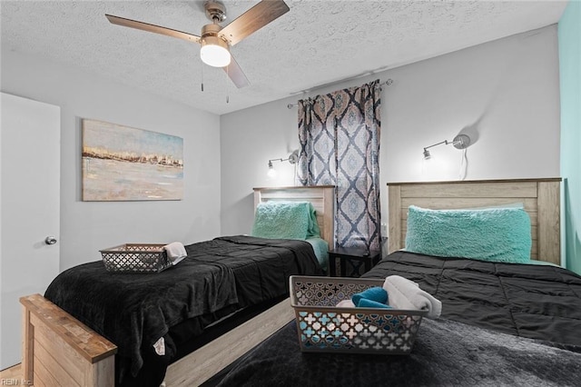 bedroom featuring a ceiling fan and a textured ceiling