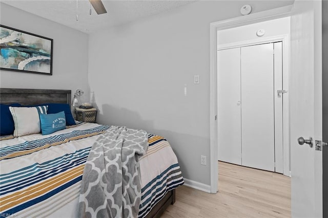 bedroom featuring ceiling fan, wood finished floors, and baseboards