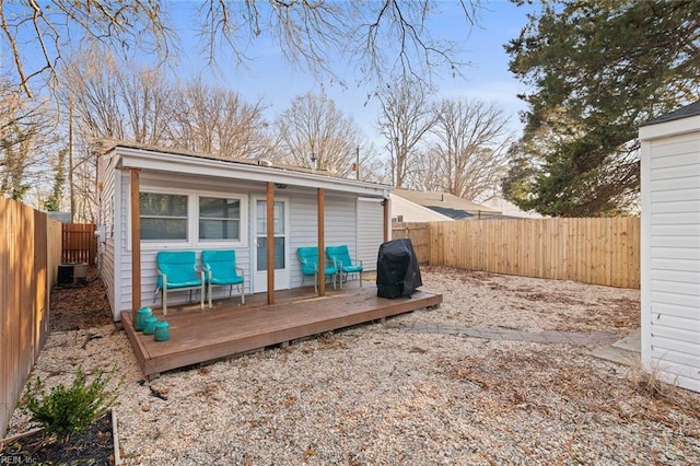 exterior space featuring a fenced backyard, a grill, and central AC