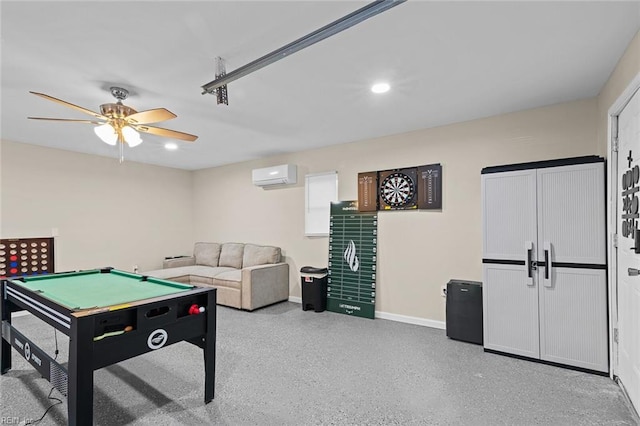 recreation room featuring light speckled floor, recessed lighting, a wall mounted AC, ceiling fan, and baseboards