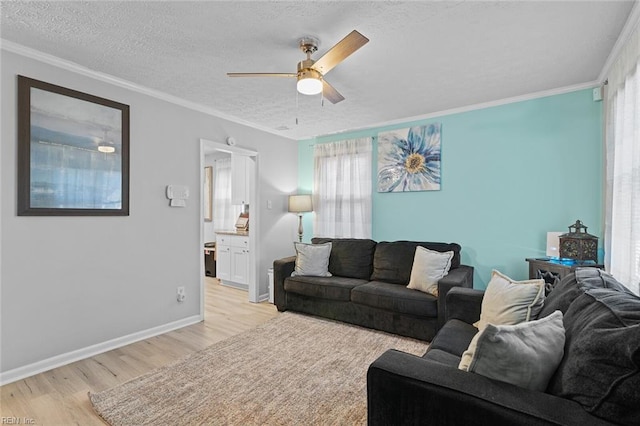 living room with a textured ceiling, light wood-type flooring, a ceiling fan, and crown molding