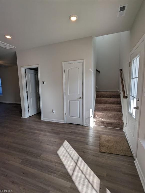 stairway featuring baseboards, visible vents, wood finished floors, and recessed lighting