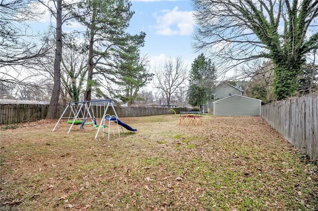 view of yard featuring a playground and a fenced backyard