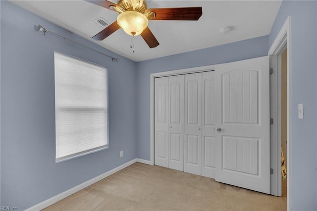 unfurnished bedroom with a ceiling fan, visible vents, baseboards, a closet, and carpet