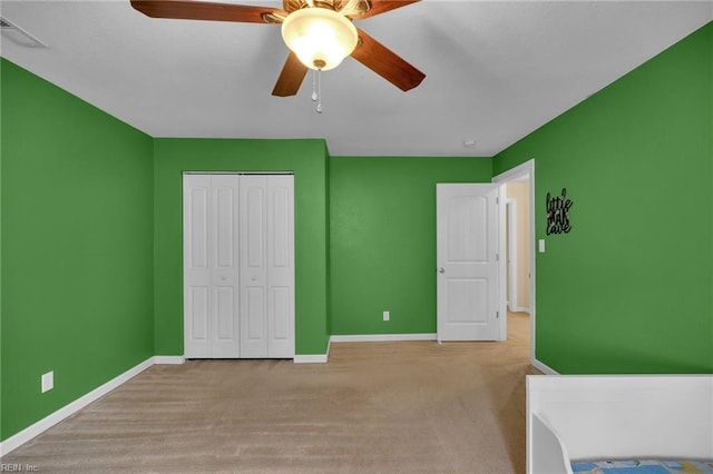 bedroom with carpet floors, baseboards, visible vents, and a closet