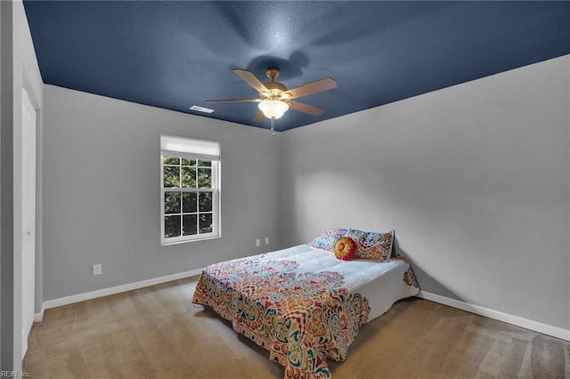 bedroom featuring visible vents, carpet flooring, a ceiling fan, and baseboards