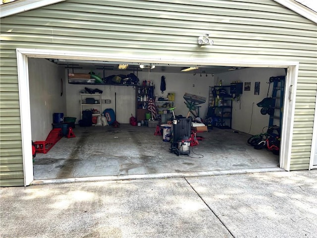 garage featuring concrete driveway