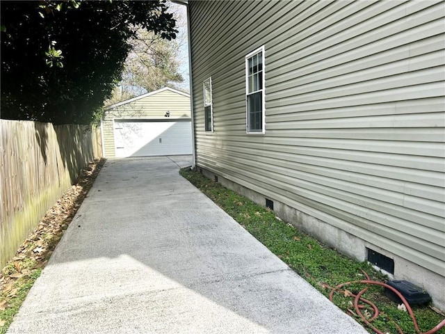 view of property exterior with a garage, an outbuilding, crawl space, and fence