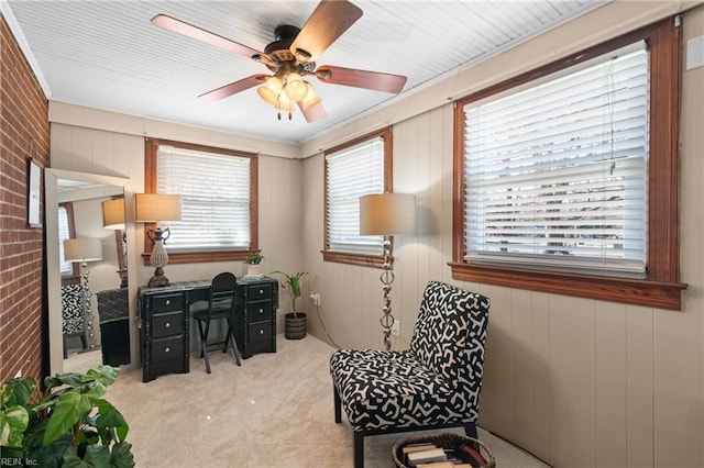 carpeted office with brick wall and ceiling fan