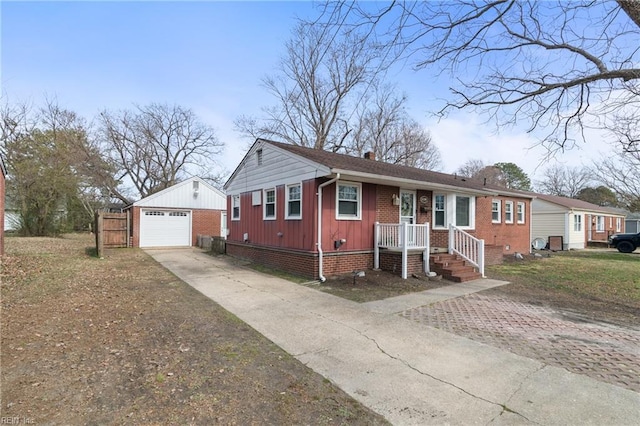 single story home featuring concrete driveway, a chimney, a detached garage, an outbuilding, and brick siding