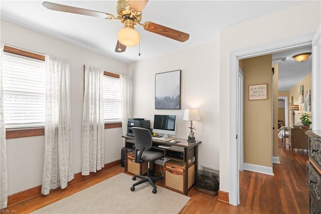 office area featuring a ceiling fan, baseboards, and wood finished floors