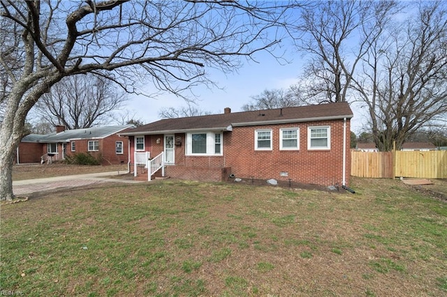 ranch-style home featuring a chimney, crawl space, fence, a front lawn, and brick siding