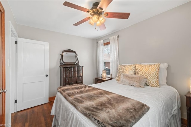 bedroom with ceiling fan and dark wood-type flooring