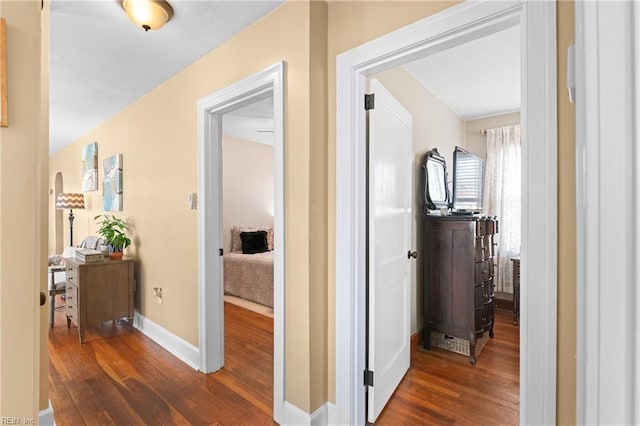 hall featuring wood finished floors and baseboards