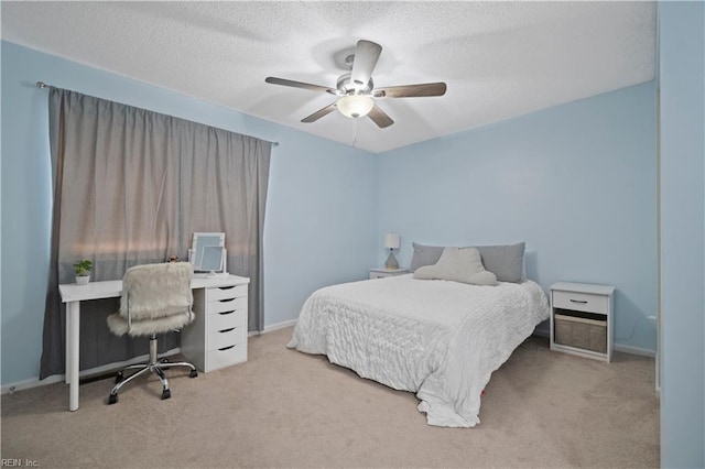 bedroom featuring a textured ceiling, carpet floors, ceiling fan, and baseboards