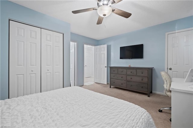 carpeted bedroom with a ceiling fan, baseboards, and a closet