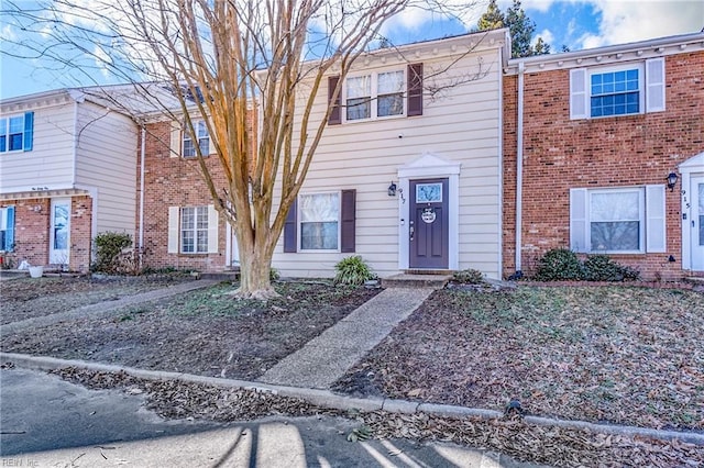 townhome / multi-family property with brick siding