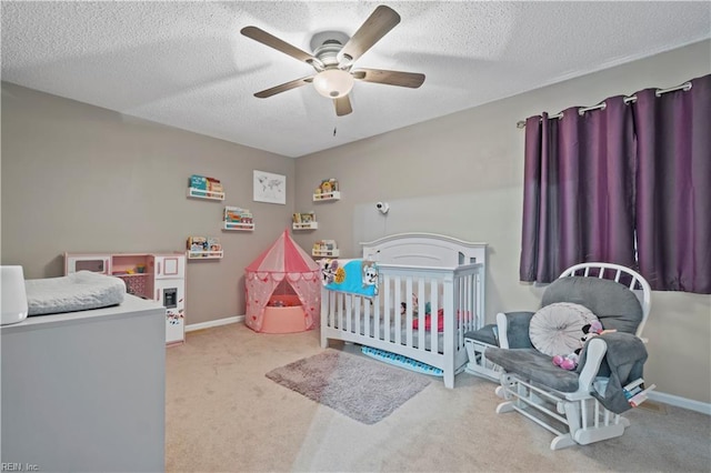 carpeted bedroom featuring ceiling fan, baseboards, and a textured ceiling