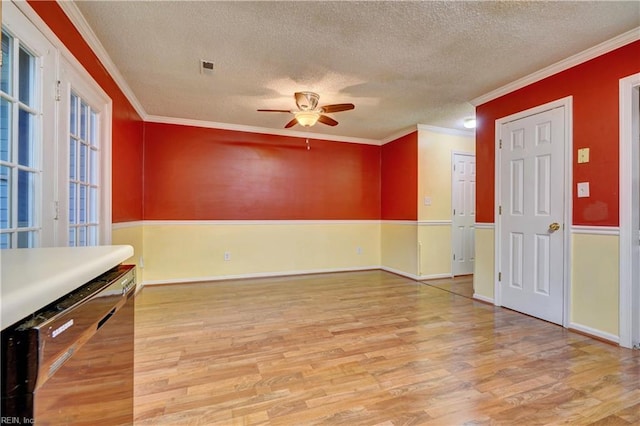 interior space with ceiling fan, crown molding, a textured ceiling, and wood finished floors