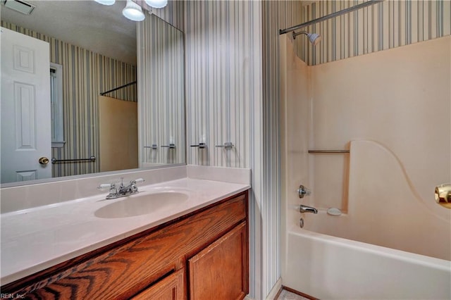 bathroom featuring wallpapered walls, shower / bath combo, visible vents, and vanity