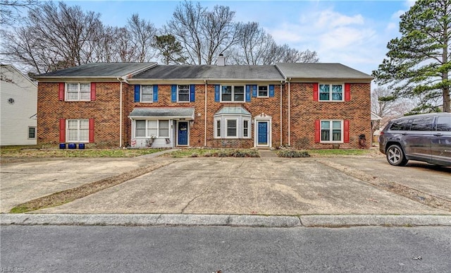 multi unit property featuring brick siding and a chimney