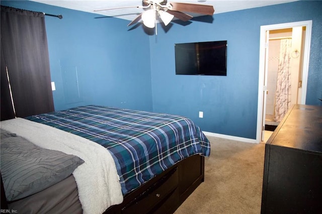 bedroom with ceiling fan, carpet, connected bathroom, and baseboards