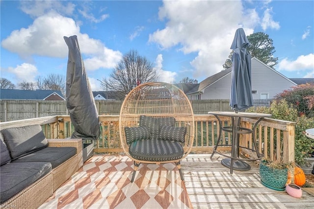 deck with a fenced backyard and outdoor lounge area