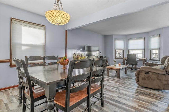 dining room with baseboards and light wood finished floors