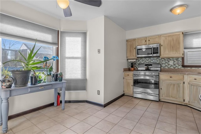 kitchen with light tile patterned floors, tasteful backsplash, baseboards, appliances with stainless steel finishes, and light brown cabinetry