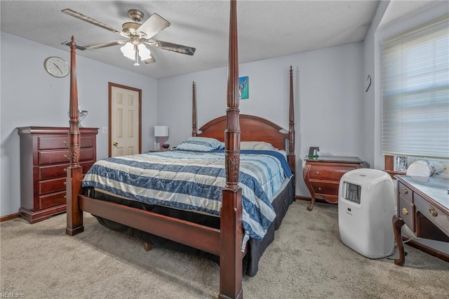 carpeted bedroom featuring ceiling fan and baseboards