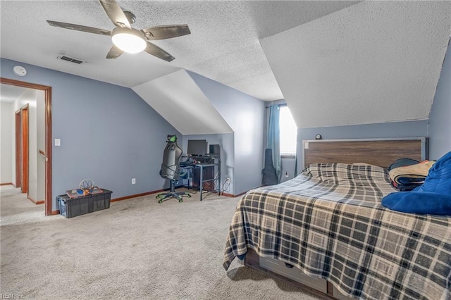 carpeted bedroom with a textured ceiling, a ceiling fan, visible vents, vaulted ceiling, and baseboards