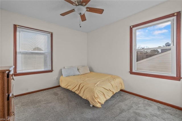 bedroom with ceiling fan, carpet floors, and baseboards