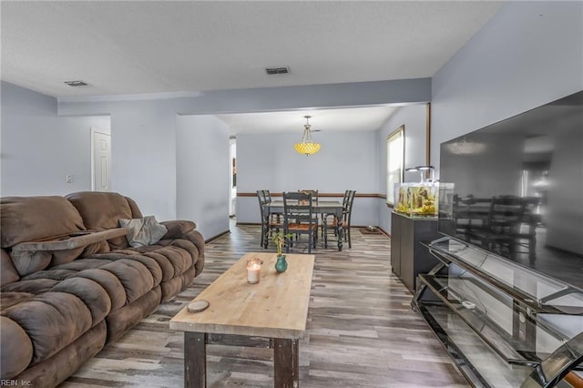 living room with wood finished floors and visible vents