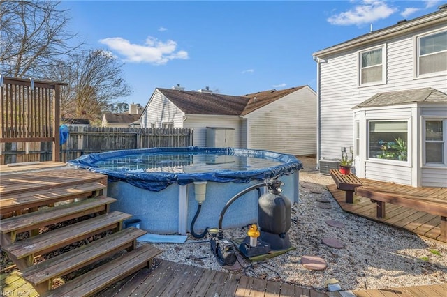 view of swimming pool featuring a fenced in pool, fence, and a deck