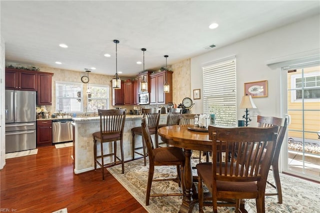 dining area with recessed lighting, visible vents, and dark wood finished floors