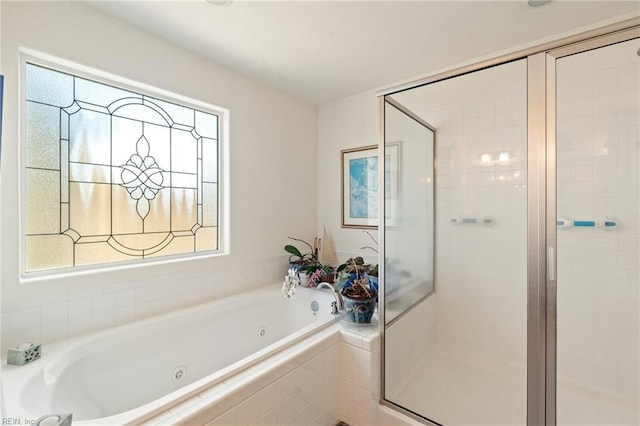 full bathroom with a shower stall and a whirlpool tub