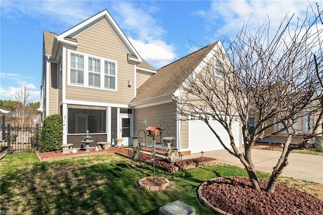 back of house with a yard, concrete driveway, a sunroom, fence, and a garage